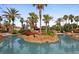 Resort-style swimming pool with palm trees and lush landscaping for a tranquil oasis at 746 Terra Lago St, Davenport, FL 33897