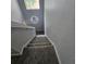 Carpeted staircase leading up to the second floor, well-lit with a unique property sign creating a welcoming entrance at 746 Terra Lago St, Davenport, FL 33897