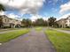 A scenic view of the neighborhood with tree-lined streets and well-maintained townhomes at 7621 Sutherton Ln, Windermere, FL 34786