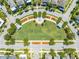 Aerial view of a meticulously landscaped community park with walking paths, gazebos, and lush greenery at 9121 Laureate Blvd, Orlando, FL 32827