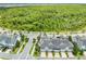 Scenic aerial view of townhomes in a neighborhood, highlighting proximity to a large forested area at 9121 Laureate Blvd, Orlando, FL 32827
