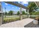 A cozy back porch features a pergola, comfortable seating, and a view of the manicured community at 9121 Laureate Blvd, Orlando, FL 32827