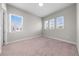 Bedroom with neutral walls, carpet flooring, white trim, and three windows providing natural light at 9121 Laureate Blvd, Orlando, FL 32827