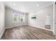 Bright and airy bedroom with crown molding, wood-look tile floors, and large windows at 9121 Laureate Blvd, Orlando, FL 32827