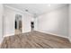 Spacious bedroom with ensuite bath access features wood-look flooring and neutral color scheme at 9121 Laureate Blvd, Orlando, FL 32827