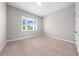 Bedroom featuring neutral walls, carpet, and a large window providing natural light at 9121 Laureate Blvd, Orlando, FL 32827