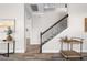 Entryway area featuring wood floors, staircase with wrought iron railing, and decor at 9121 Laureate Blvd, Orlando, FL 32827