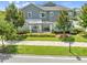 Charming townhome with a covered front porch perfect for relaxing, set amidst lush landscaping and green lawns at 9121 Laureate Blvd, Orlando, FL 32827