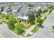 Well-maintained gray home featuring a covered porch, complemented by a landscaped front yard and lush street trees at 9121 Laureate Blvd, Orlando, FL 32827