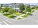 Gorgeous two-story gray home featuring craftsman style design with a welcoming front porch with lovely trees at 9121 Laureate Blvd, Orlando, FL 32827