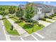 Attractive townhomes feature well-maintained landscaping, sidewalks, and private garages in a desirable community at 9121 Laureate Blvd, Orlando, FL 32827