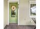 Charming front porch with a green door, white trim, and the house number 9121 at 9121 Laureate Blvd, Orlando, FL 32827