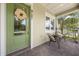 Inviting front porch featuring a green door, seating area, and manicured landscaping at 9121 Laureate Blvd, Orlando, FL 32827