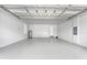 Spacious two-car garage features a bright white painted walls and floor, and includes a water heater at 9121 Laureate Blvd, Orlando, FL 32827