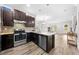 Modern kitchen featuring stainless steel appliances, mosaic backsplash, and wood-look tile flooring at 9121 Laureate Blvd, Orlando, FL 32827