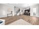 Bright, open-concept living room with hardwood floors and staircase to the second floor at 9121 Laureate Blvd, Orlando, FL 32827