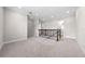 Large loft area with neutral carpeting, crown molding, recessed lighting, and staircase at 9121 Laureate Blvd, Orlando, FL 32827