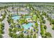 Aerial view of a resort-style community pool with multiple pools, palm trees, lounge chairs, and ample recreation areas at 9121 Laureate Blvd, Orlando, FL 32827
