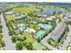 Aerial view showcasing a community pool complex with various pool types and recreational facilities by a serene lake at 9121 Laureate Blvd, Orlando, FL 32827