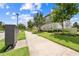A street view shows lush landscaping along the sidewalk and the townhome-style condos in the community at 9121 Laureate Blvd, Orlando, FL 32827