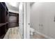 Spacious walk-in closet with custom shelving and drawers leading to a half bathroom at 9121 Laureate Blvd, Orlando, FL 32827