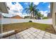 Backyard view with tall palm trees, white privacy fence, and patio at 10934 Rushwood Way, Clermont, FL 34714