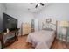 Bedroom with a bed, dresser, TV, and side table at 10934 Rushwood Way, Clermont, FL 34714