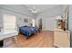 Bedroom with wood floors, desk, closet and grey walls at 10934 Rushwood Way, Clermont, FL 34714