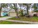 Inviting one story home featuring manicured lawn, mature trees, and charming curb appeal at 10934 Rushwood Way, Clermont, FL 34714