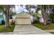 Inviting one story home featuring manicured lawn, mature trees, and charming curb appeal at 10934 Rushwood Way, Clermont, FL 34714