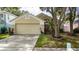 Inviting one story home featuring manicured lawn, mature trees, and charming curb appeal at 10934 Rushwood Way, Clermont, FL 34714