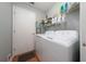 Laundry room with washer, dryer, shelving, and a white door at 10934 Rushwood Way, Clermont, FL 34714