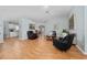 Bright living room with laminate flooring, modern furniture, and neutral wall colors at 10934 Rushwood Way, Clermont, FL 34714