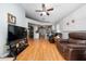 Open living room featuring laminate floors and a view of the kitchen at 10934 Rushwood Way, Clermont, FL 34714