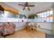 Covered patio has tile floors, ceiling fan, and table with seating at 10934 Rushwood Way, Clermont, FL 34714