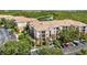 Beautiful aerial view of the condominium complex, showcasing the landscaping, lake and parking at 1351 Venezia Ct # 201, Davenport, FL 33896