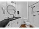 Modern bathroom with black countertop, sleek fixtures, and walk-in shower that create a clean and sophisticated space at 1351 Venezia Ct # 201, Davenport, FL 33896
