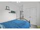 Bright bedroom featuring neutral walls, updated lighting, and a comfortable bed with stylish accents at 1351 Venezia Ct # 201, Davenport, FL 33896