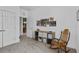 Spacious bedroom offers comfortable rocking chair, storage solutions, and hallway access, maximizing space and functionality at 1351 Venezia Ct # 201, Davenport, FL 33896