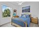 Serene bedroom featuring a wood bed, a cityscape art piece, and windows that provide a calming and stylish retreat at 1351 Venezia Ct # 201, Davenport, FL 33896