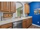 Kitchen featuring updated countertops, stainless steel dishwasher and wood cabinets at 1351 Venezia Ct # 201, Davenport, FL 33896