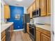 Efficient kitchen features stainless steel appliances, wood cabinets, and durable countertops at 1351 Venezia Ct # 201, Davenport, FL 33896
