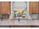 Kitchen with open view to living area beyond the sink, cabinets and faucet at 1351 Venezia Ct # 201, Davenport, FL 33896