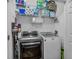 Convenient laundry room with modern washer and dryer, ample storage shelves, and efficient organization at 1351 Venezia Ct # 201, Davenport, FL 33896