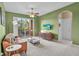 Relaxing living room leads to a balcony, enhanced by a ceiling fan and natural light at 1351 Venezia Ct # 201, Davenport, FL 33896