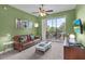 Inviting living room with a balcony and view of the landscaped surroundings at 1351 Venezia Ct # 201, Davenport, FL 33896