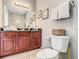 Bathroom featuring a granite countertop, stylish faucet, and a large mirror reflecting the shower at 1361 Tuscan Ter # 7303, Davenport, FL 33896