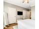 Bedroom featuring a TV, white doors, a full-length mirror, and a modern ceiling fan at 1361 Tuscan Ter # 7303, Davenport, FL 33896