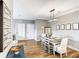Open-concept dining area with stylish decor, wood floors, and seamless flow to the kitchen and living spaces at 1361 Tuscan Ter # 7303, Davenport, FL 33896