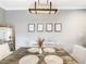 Dining table with four settings and modern lighting fixture at 1361 Tuscan Ter # 7303, Davenport, FL 33896